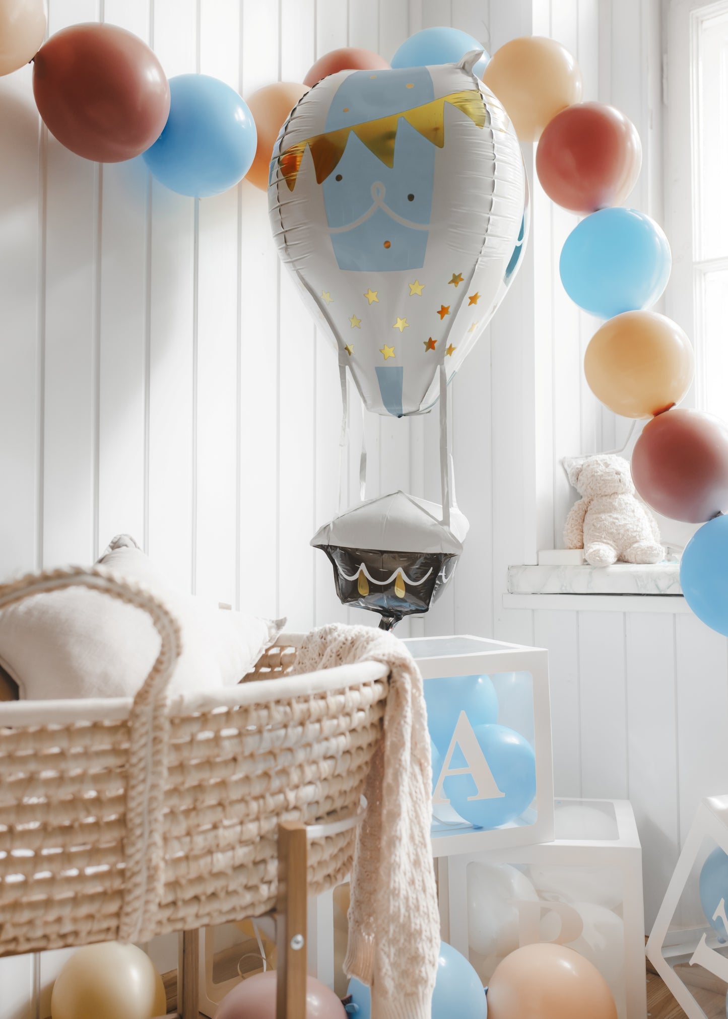 Children's room with colorful balloons and a baby crib.