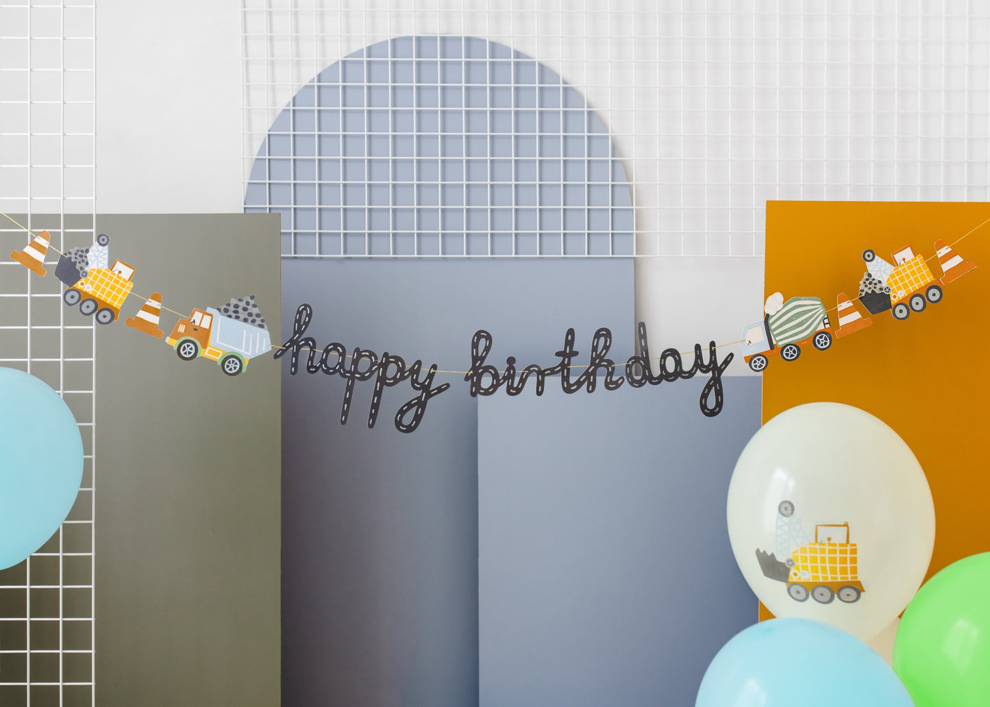 Birthday banner with black script text and decorations of construction trucks and traffic cones, perfect for kids' builder-themed celebrations