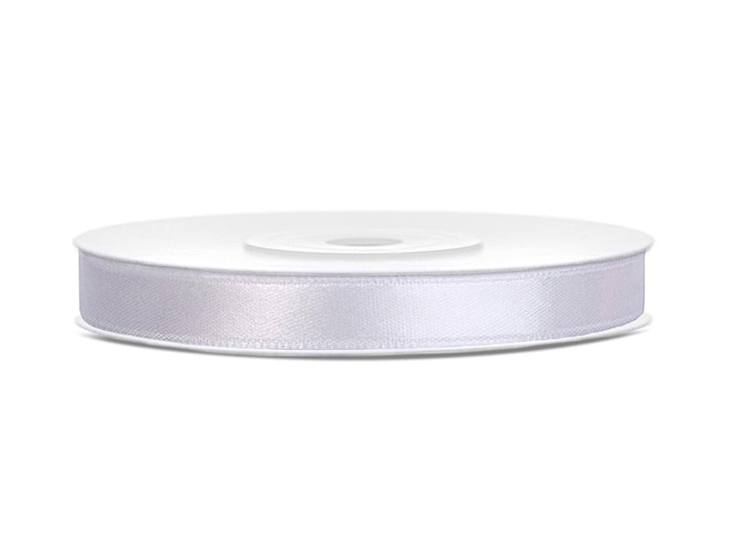 Roll of white satin ribbon on a white background
