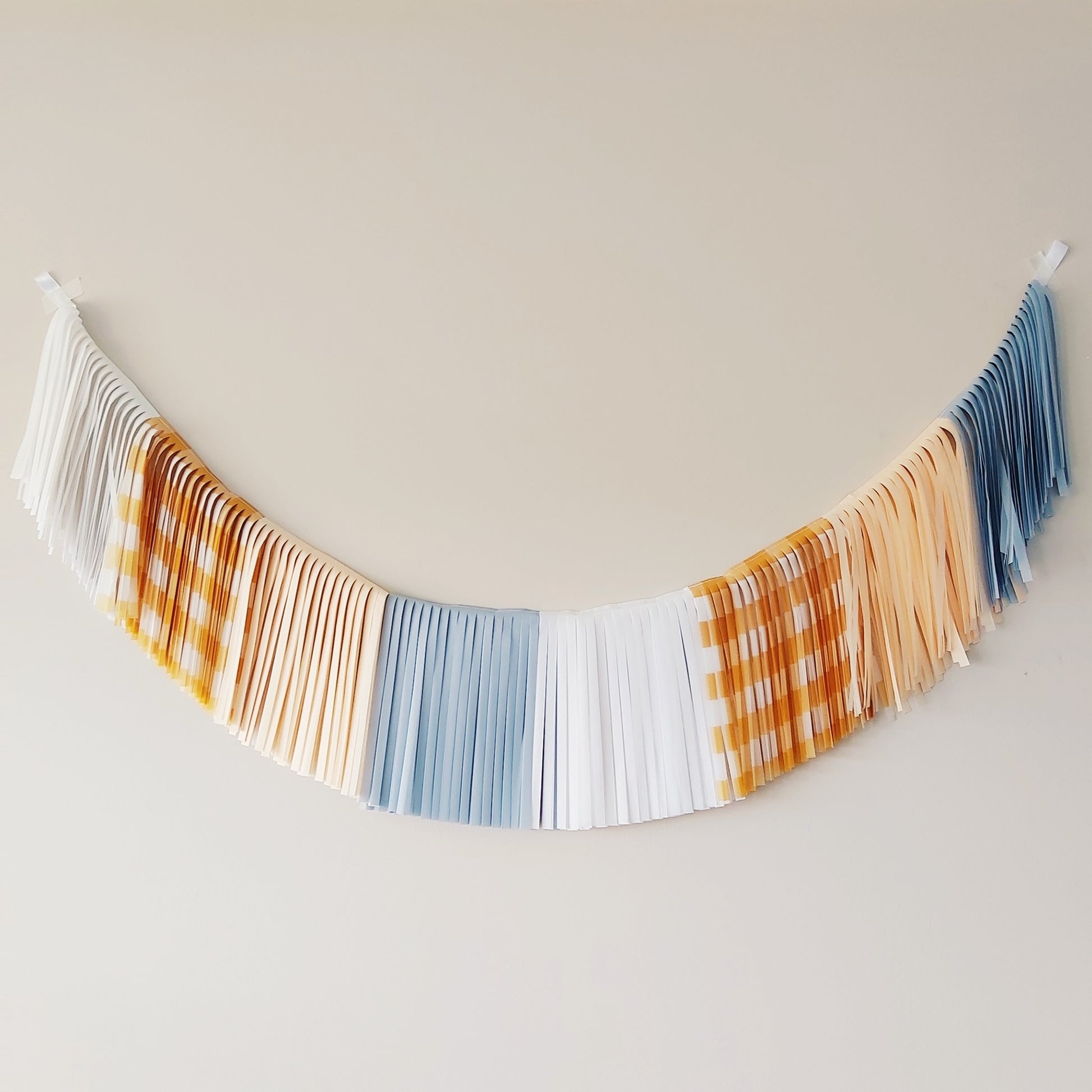 Decorative string banner with checkered pattern on a plain background