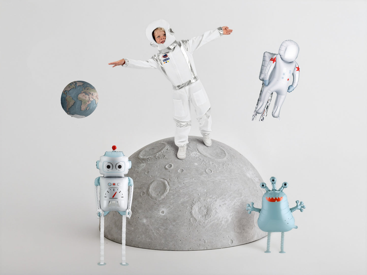 astronaut, robot, and alien on a moon-shaped object with a gray background