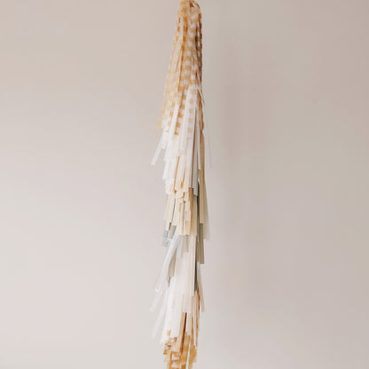 Decorative hanging with ribbons on a plain background