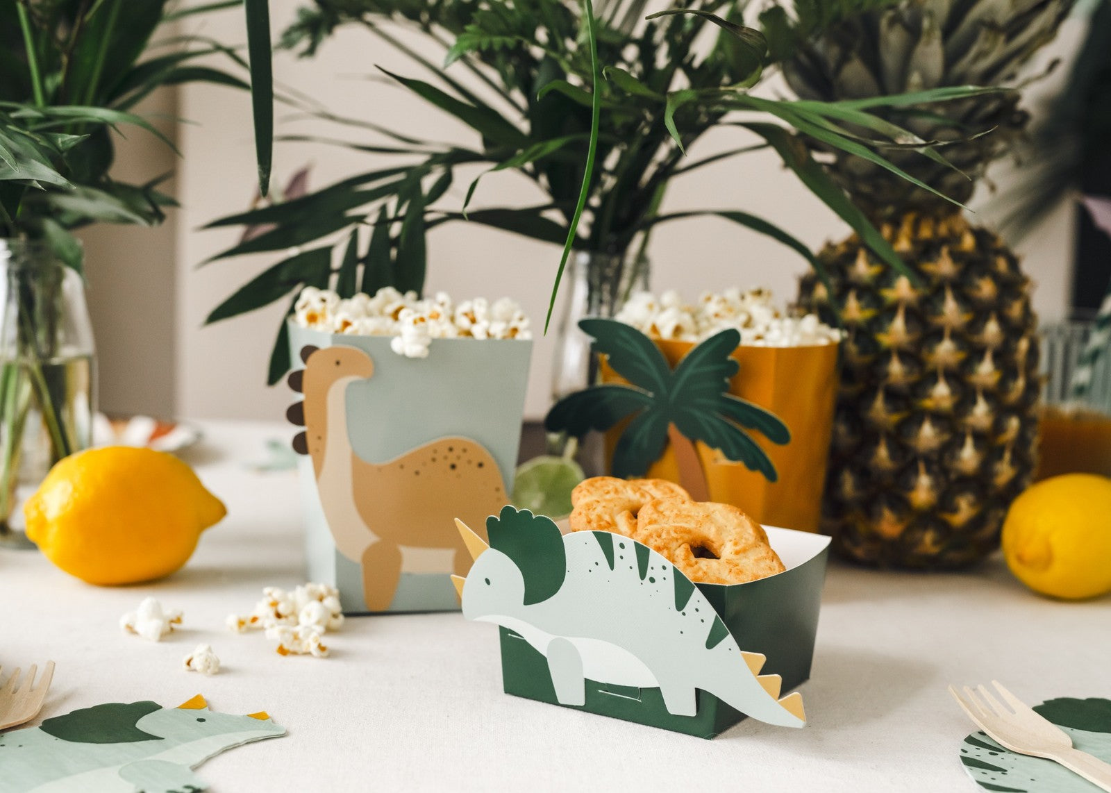 Dinosaur snack boxes in brontosaurus, triceratops and palm tree designs for kids birthday party treats