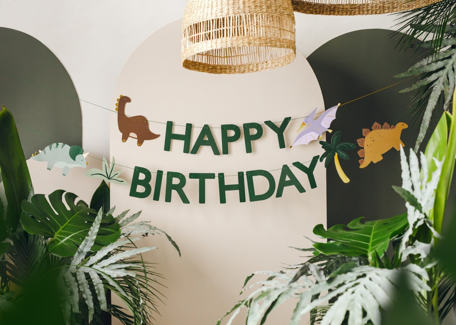 Happy Birthday banner with green dinosaurs and jungle leaves for prehistoric party decor
