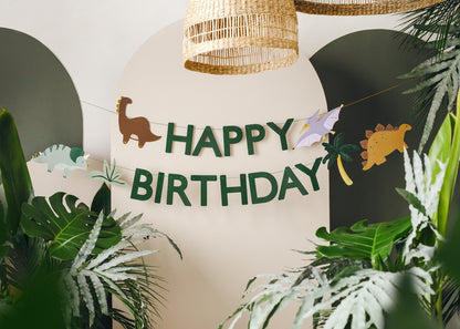 Happy Birthday banner with green dinosaurs and jungle leaves for prehistoric party decor