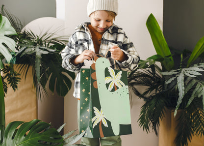 Green dinosaur gift bag with palm tree design for kids birthday favors