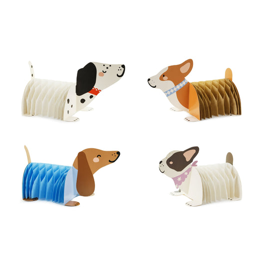 Set of four paper dog models with different breeds and colors on a white background