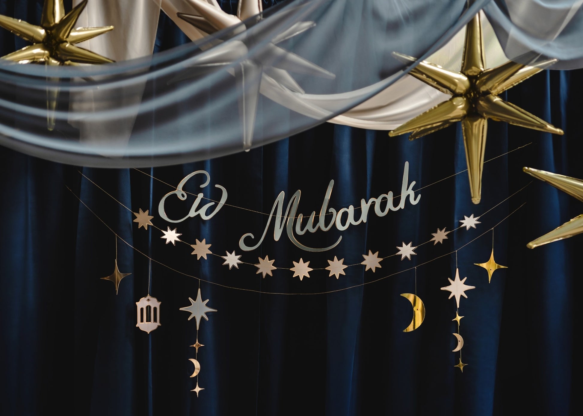 Decorative banner with 'Eid Mubarak' text and stars on a blue background