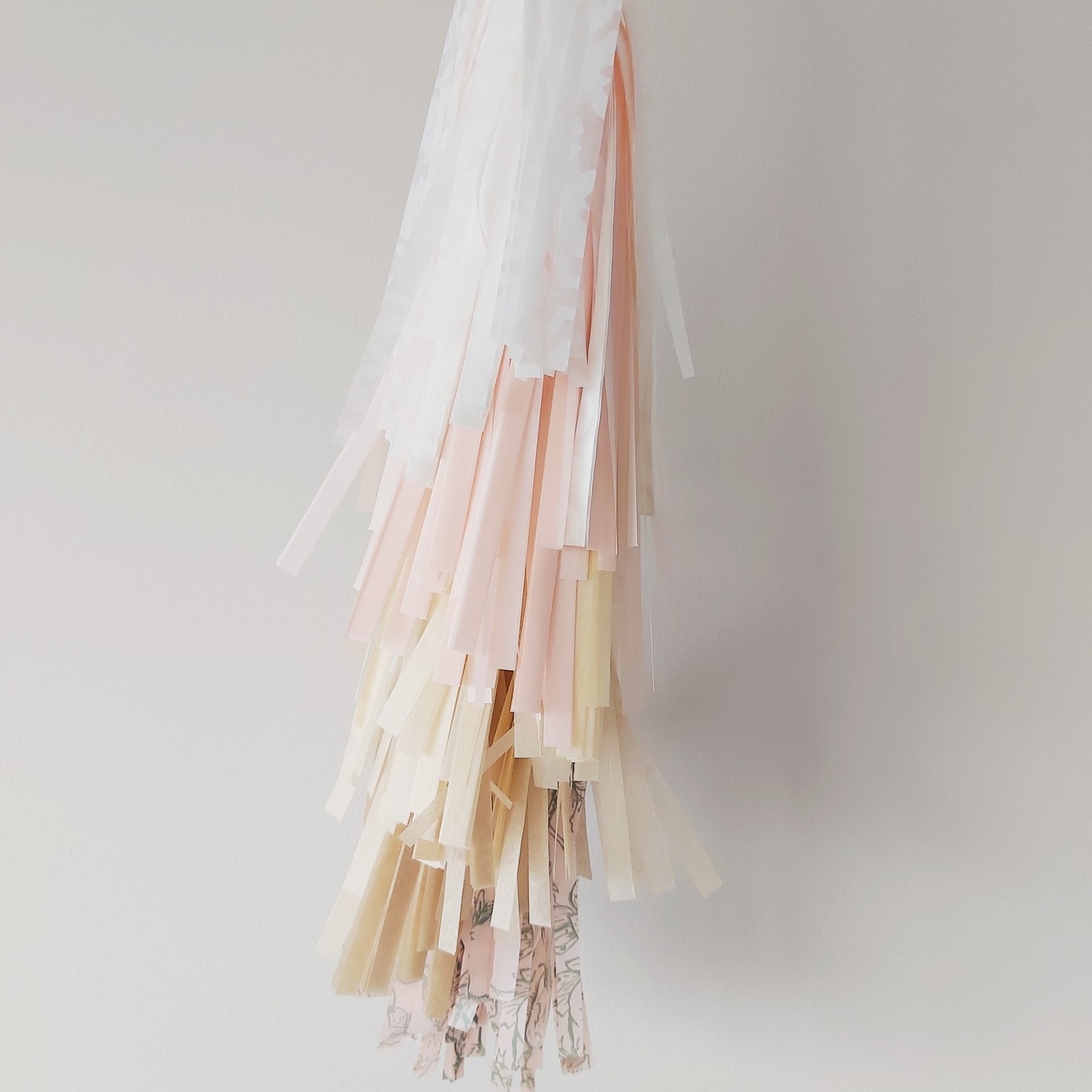 Pastel-colored tassel decorations on a plain background