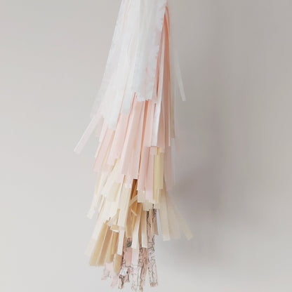 Pastel-colored tassel decorations on a plain background