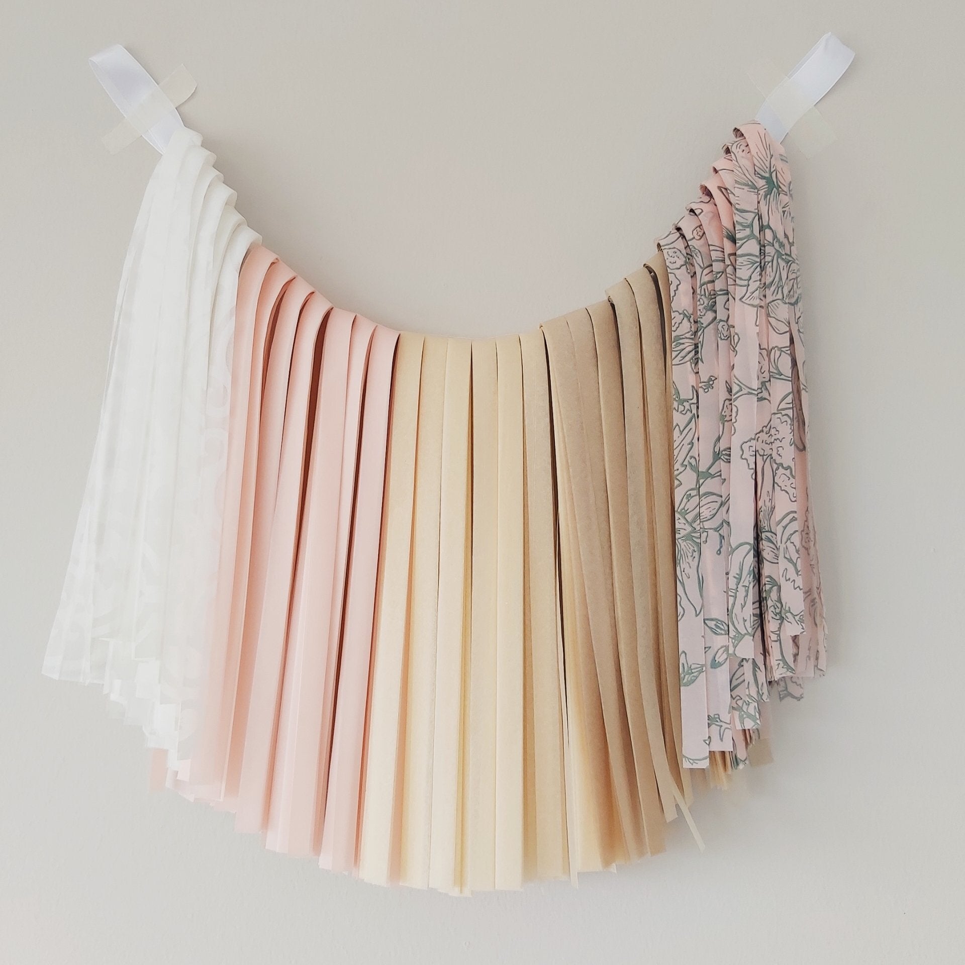 Pastel pleated skirt with floral patterned top on a white background