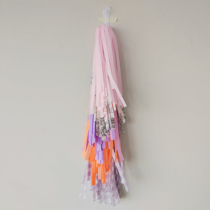 Colorful tassel decoration hanging on a plain wall
