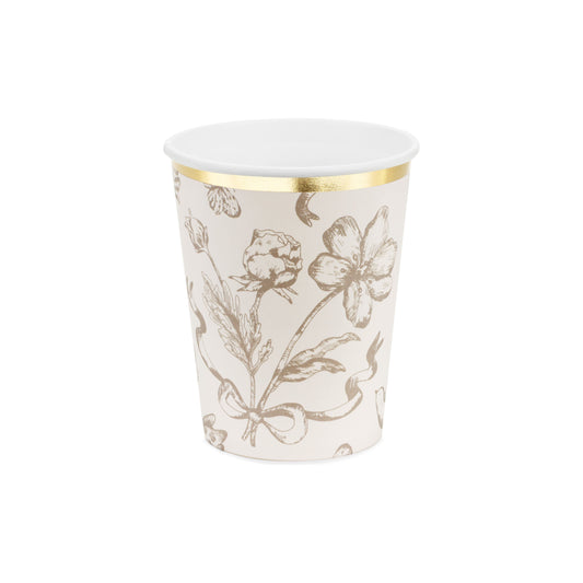White paper cup with gold floral pattern on a white background