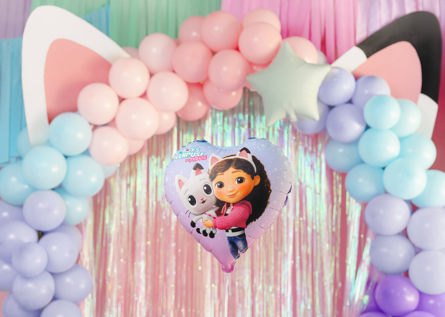 Decorative arch with balloons and a heart-shaped balloon featuring a cartoon character.