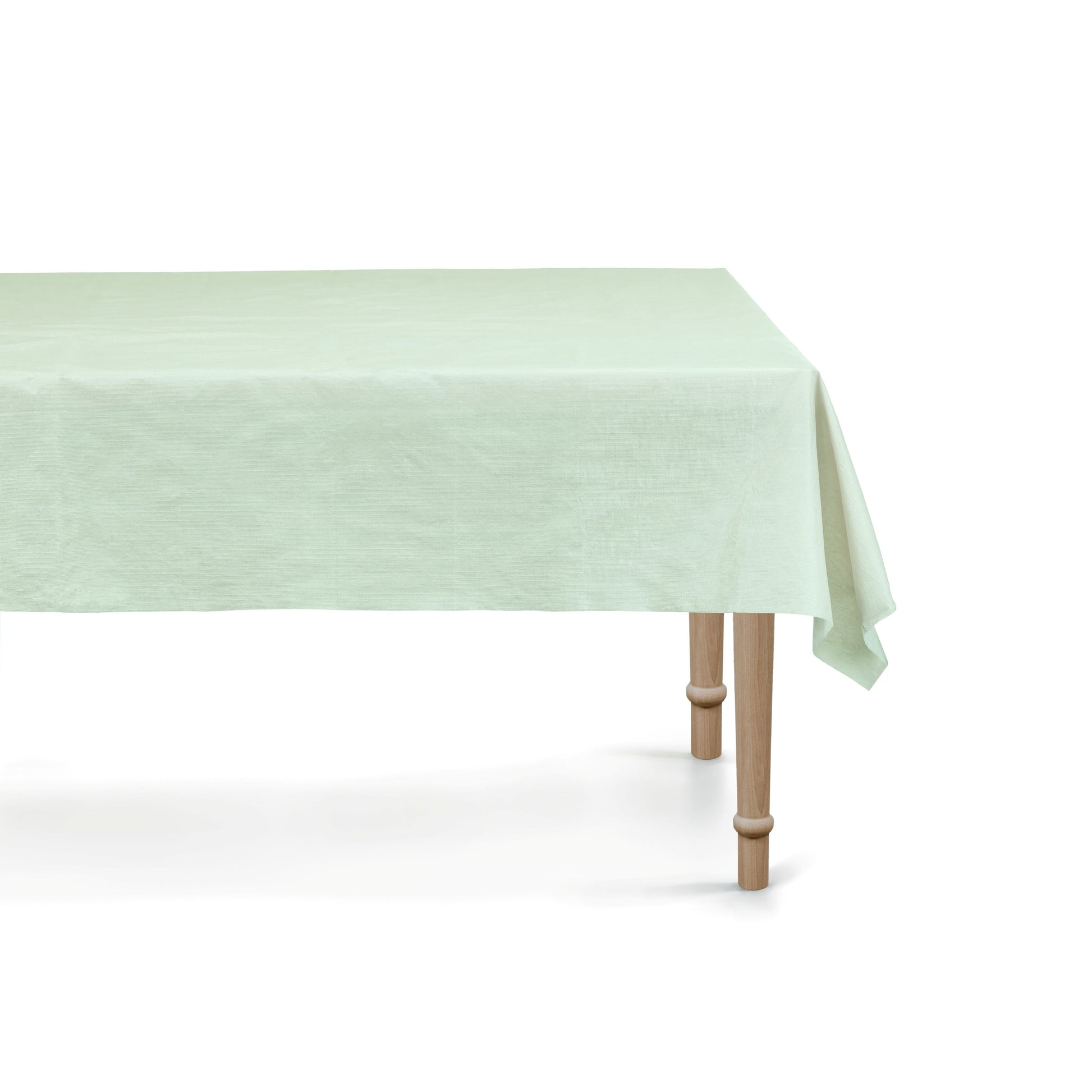 Light green tablecloth on a wooden table with a white background