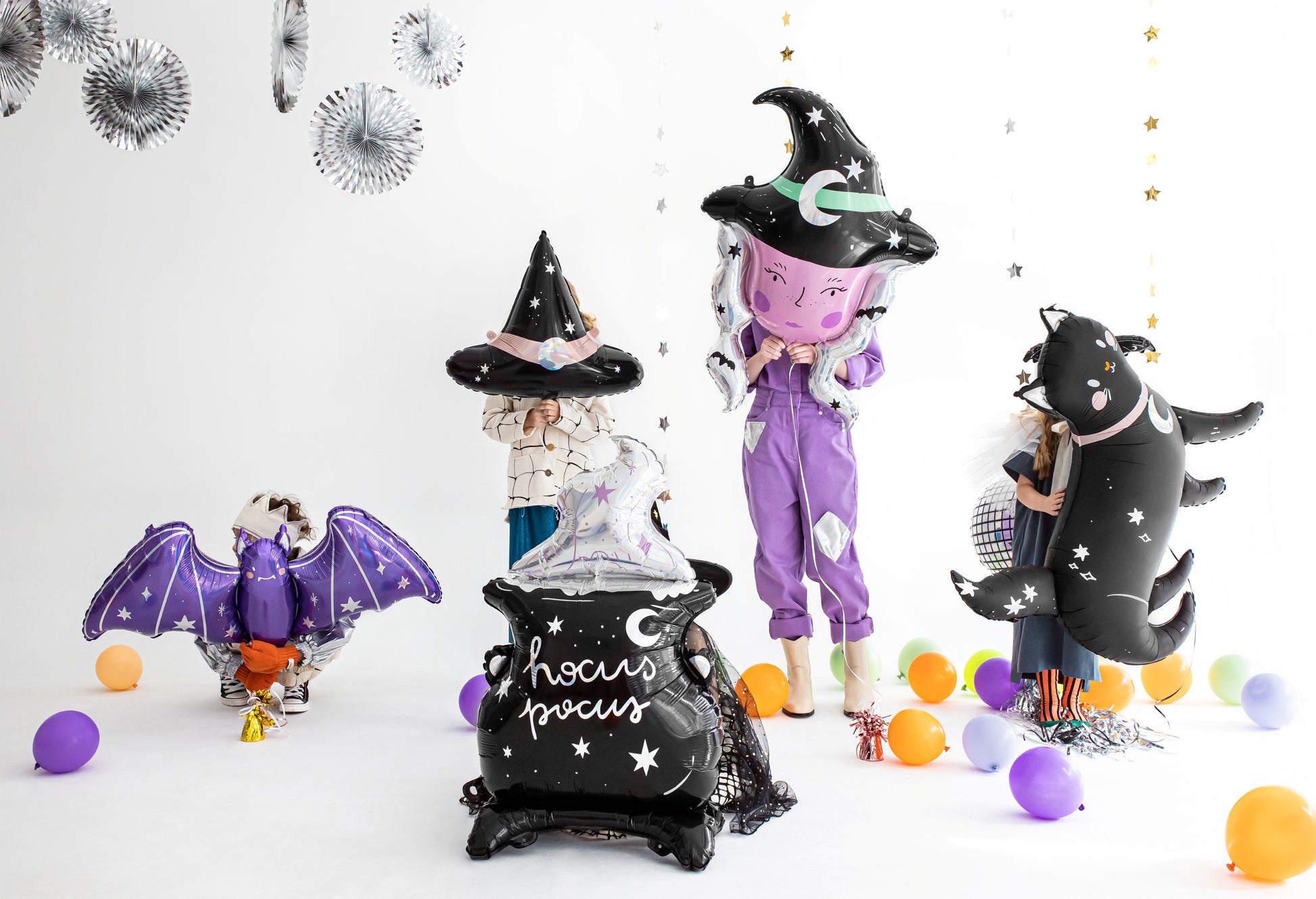 Halloween-themed balloons including a witch, bat, and cat on a white background.
