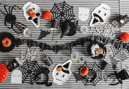 Halloween-themed treats and decorations on a striped background