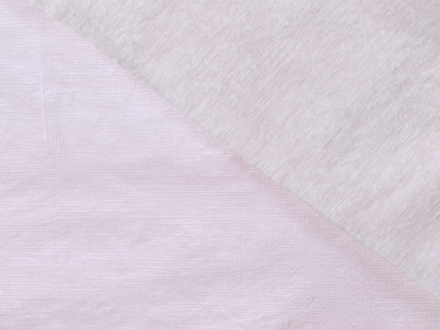Close-up of textured white fabric with a diagonal pattern
