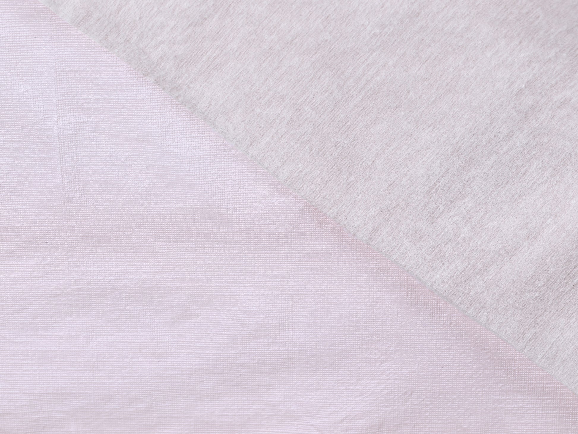 Close-up of textured white fabric with a diagonal pattern