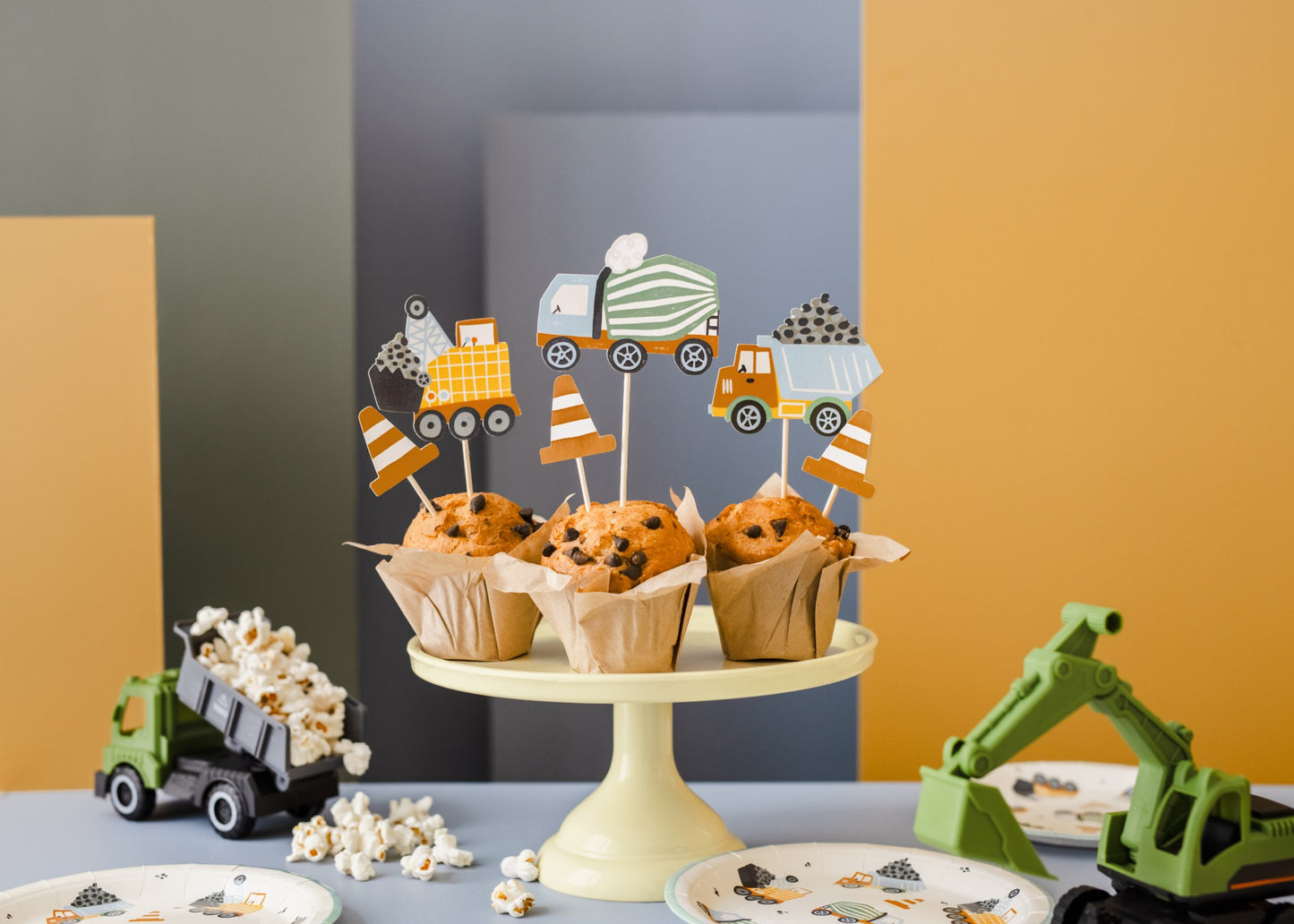 Chocolate chip cupcakes decorated with construction vehicle and traffic cone toppers, perfect for kids' construction-themed birthday party