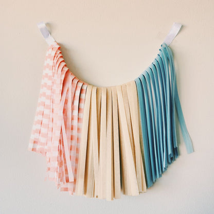 Colorful fringe skirt with pastel shades on a beige background