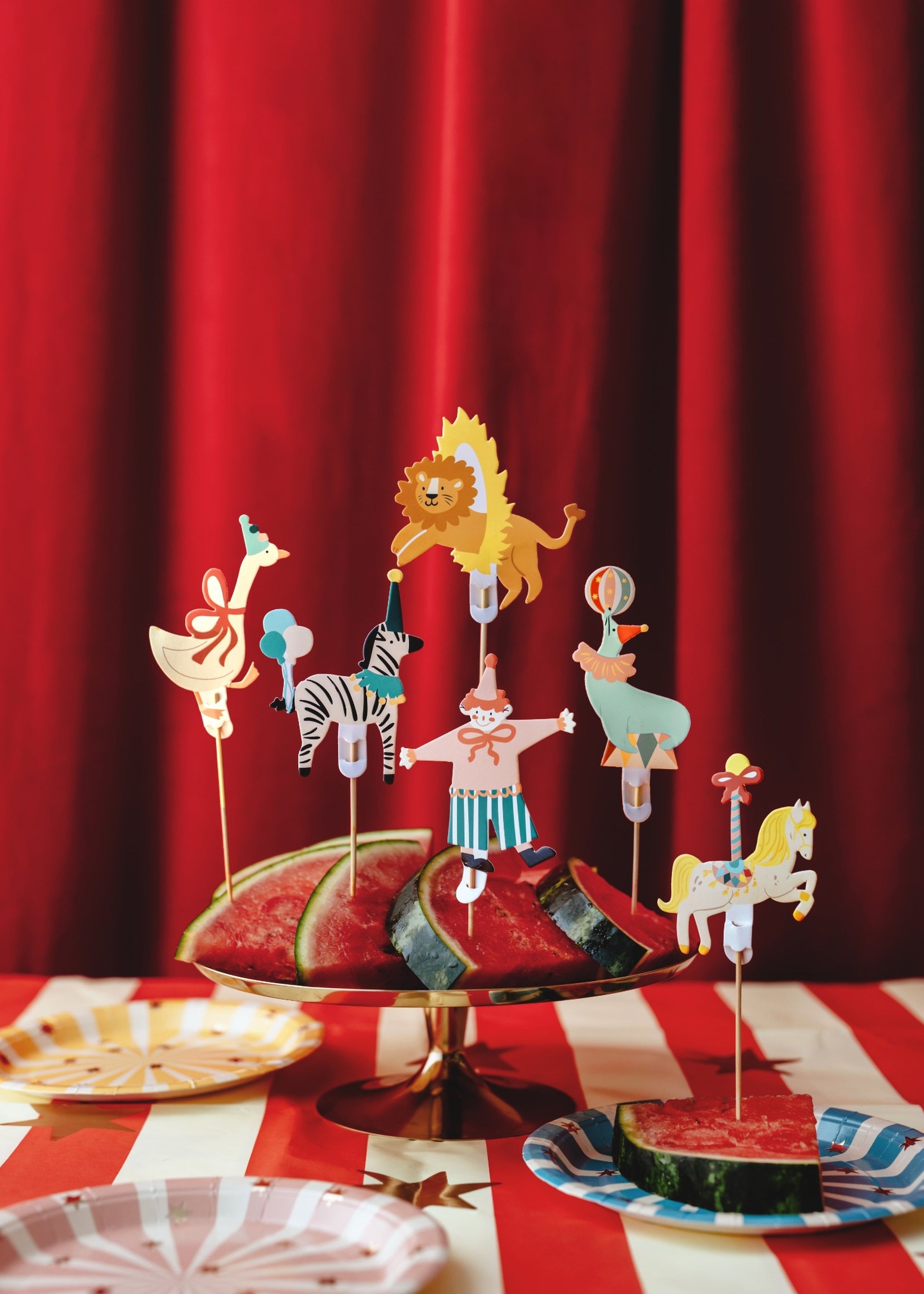 Set of six circus-themed cupcake toppers featuring a clown, seal with ball, zebra with balloons, lion jumping through a hoop, carousel horse, and goose with a red bow