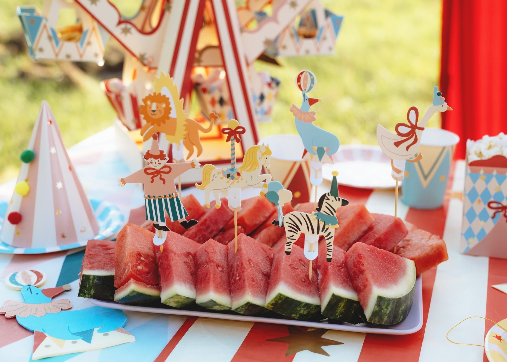 Set of six circus-themed cupcake toppers featuring a clown, seal with ball, zebra with balloons, lion jumping through a hoop, carousel horse, and goose with a red bow