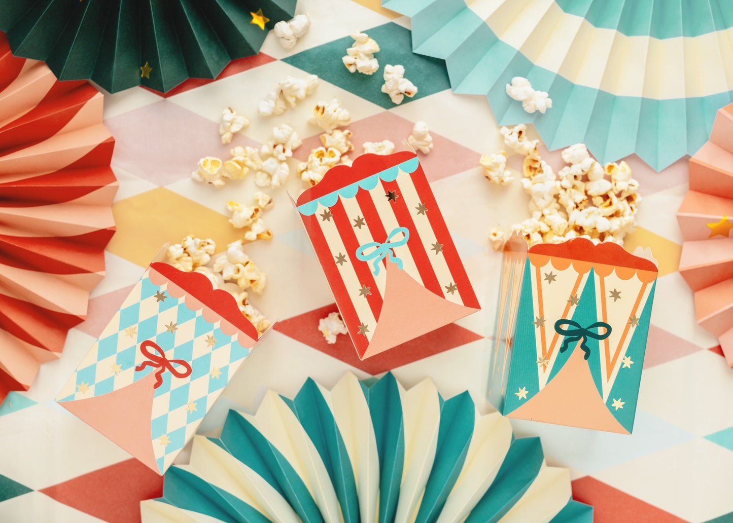 Popcorn or snack boxes with circus tent patterns in red, blue, and pastel designs decorated with stars and bows
