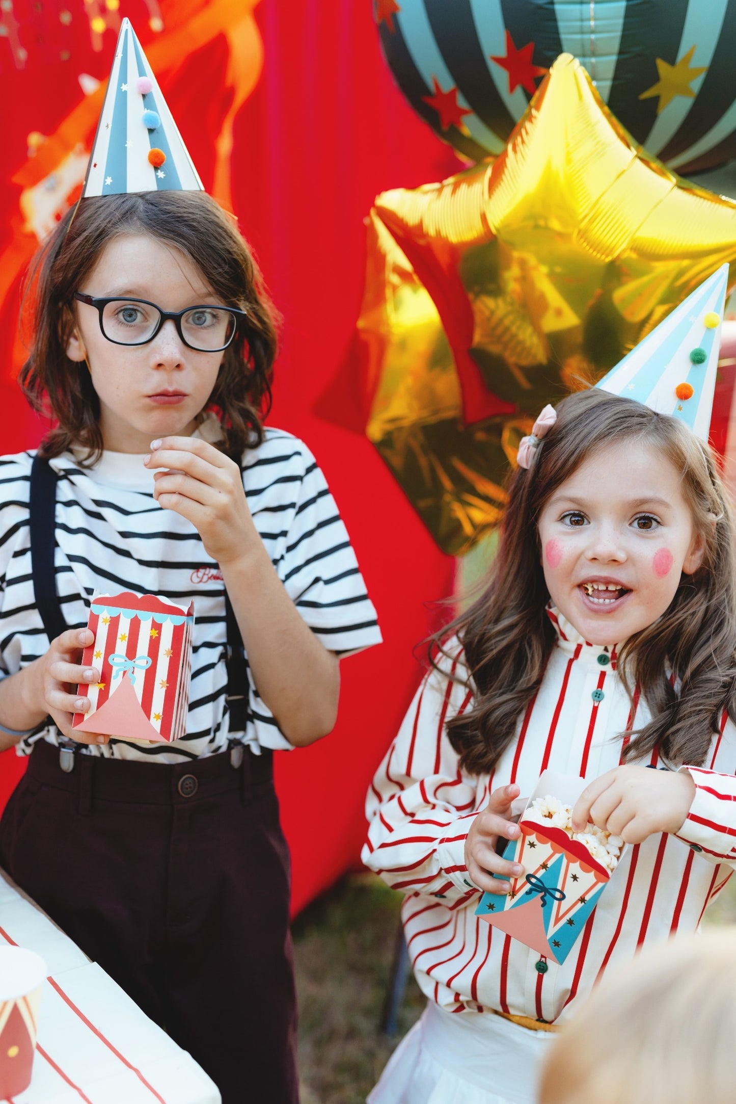 Popcorn or snack boxes with circus tent patterns in red, blue, and pastel designs decorated with stars and bows