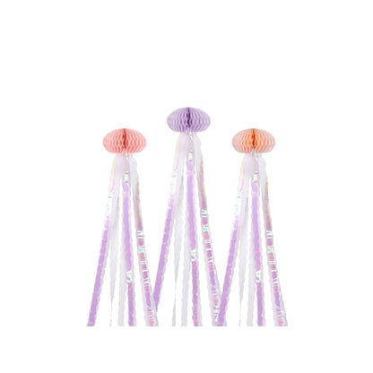 Decorative tassels with pink and purple pom-poms on a white background