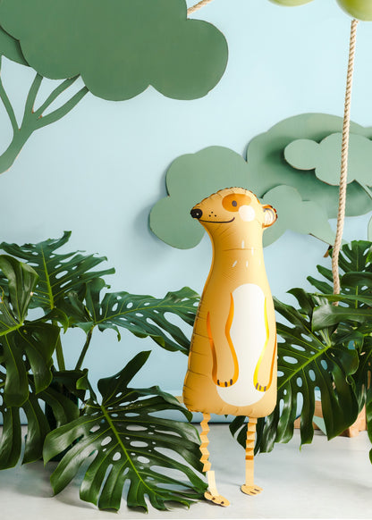 Decorative meerkat figure with a light blue background and green leaves.