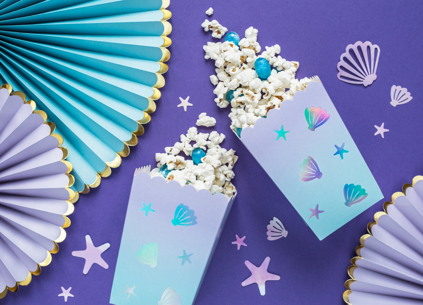 Ocean-themed popcorn boxes decorated with pastel seashell and star designs — ideal for party snacks.