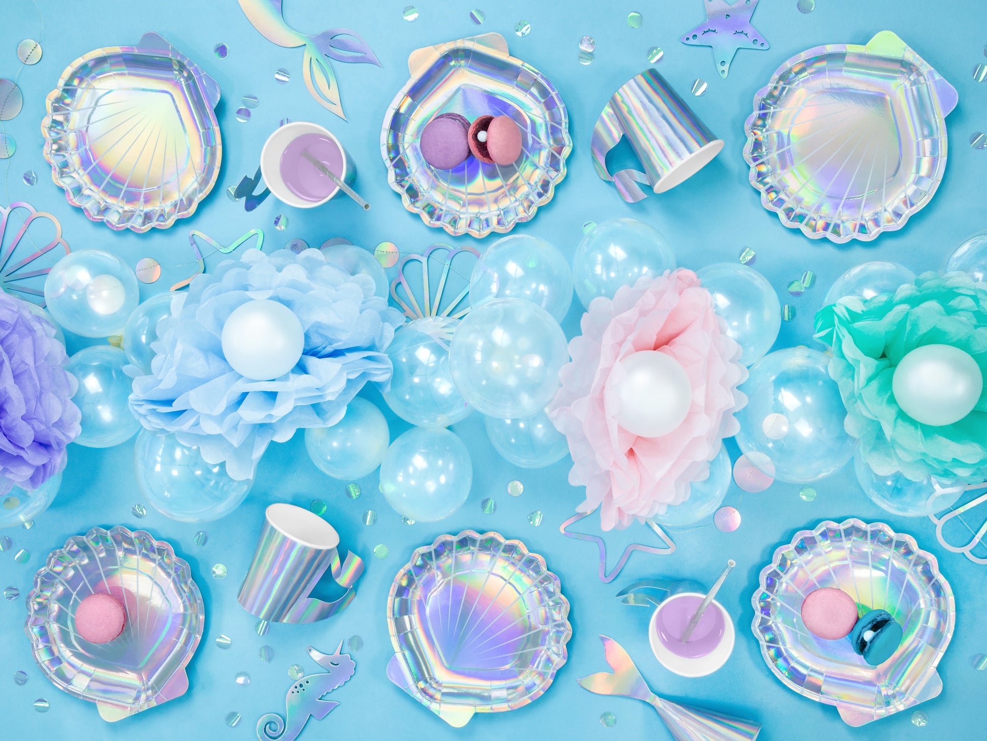 Iridescent paper plates shaped like seashells — perfect for mermaid or under the sea birthday parties.