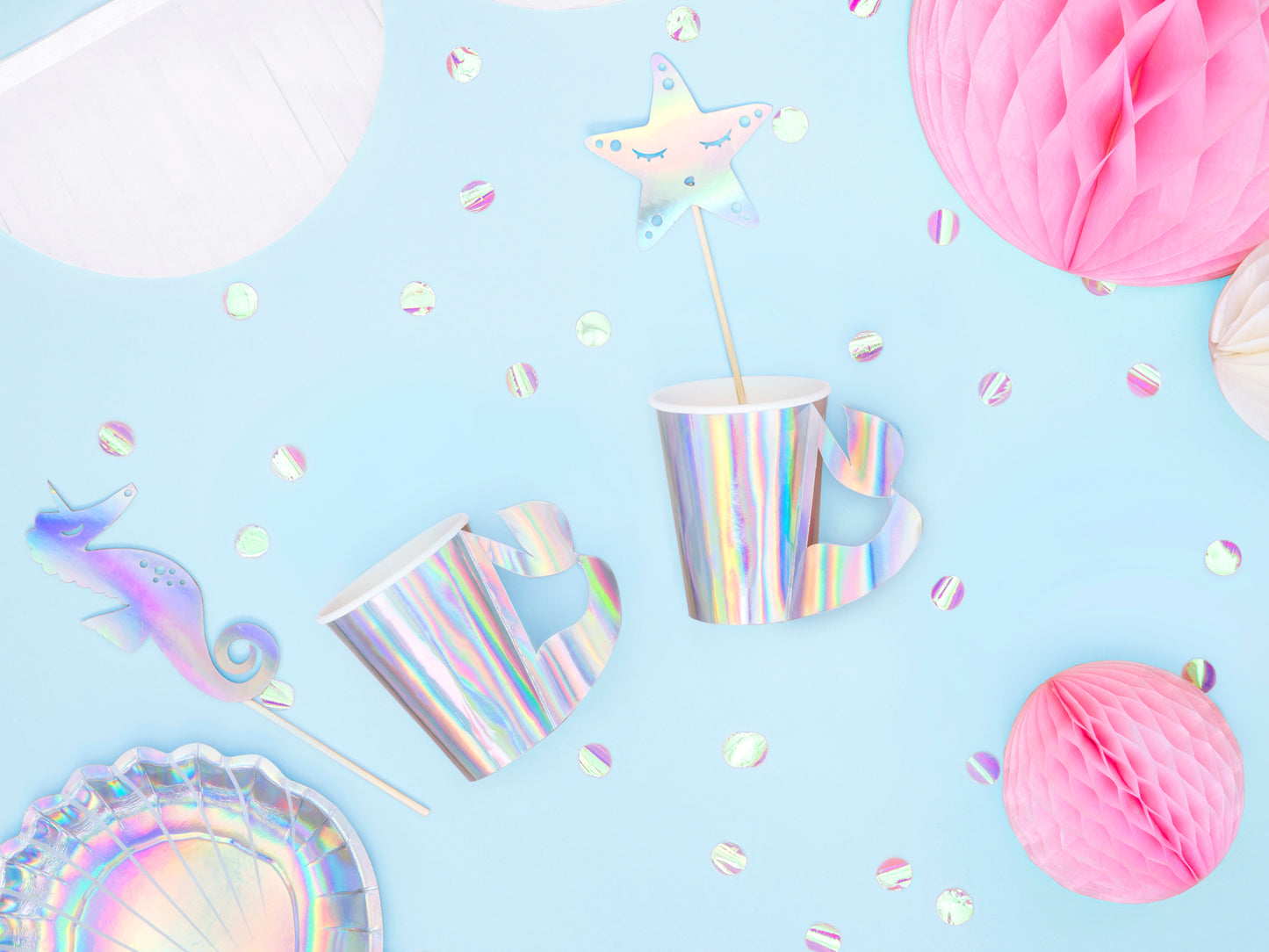 Iridescent paper cups with mermaid tail-shaped handles — ideal for kids' ocean-themed parties.
