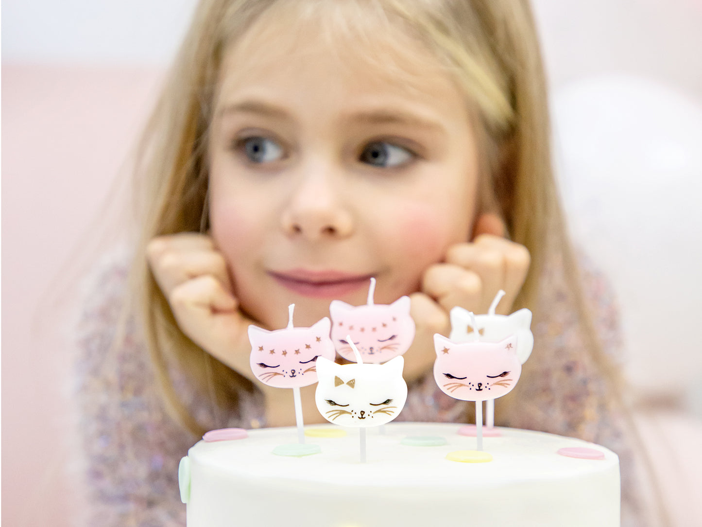 Adorable cat face birthday candles in pink and white, perfect cake toppers for kitty-themed celebrations.