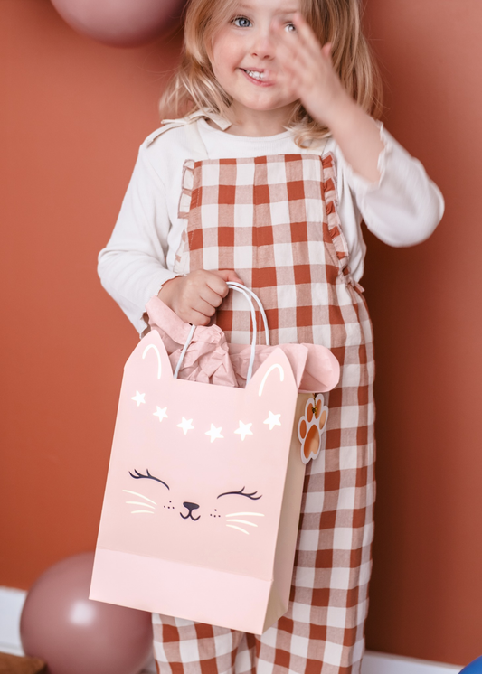 Pink gift bag with cat face and star design, ideal for party favors or birthday gifts for cat-themed celebrations.