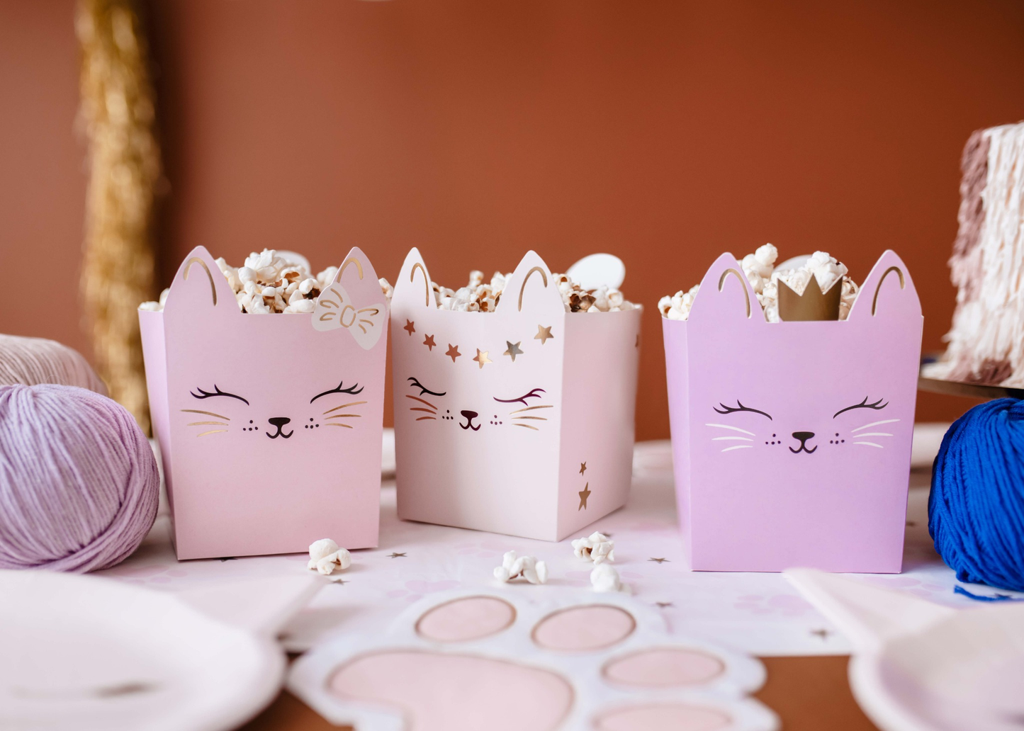 Set of pastel kitty-themed snack boxes with cute cat faces and gold details, perfect for holding treats at kitty birthday parties or cat-themed celebrations.