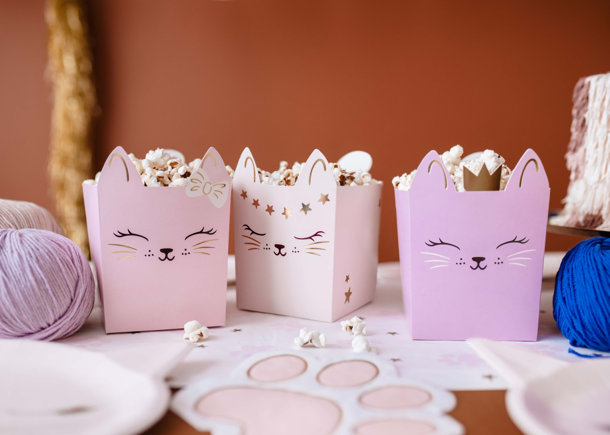 Set of pastel kitty-themed snack boxes with cute cat faces and gold details, perfect for holding treats at kitty birthday parties or cat-themed celebrations.