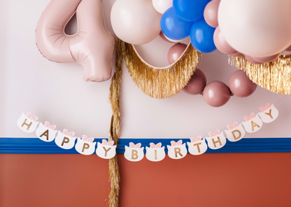 Cute "Happy Birthday" banner with cat face cutouts and pink bows, perfect for kitty-themed party decoration.