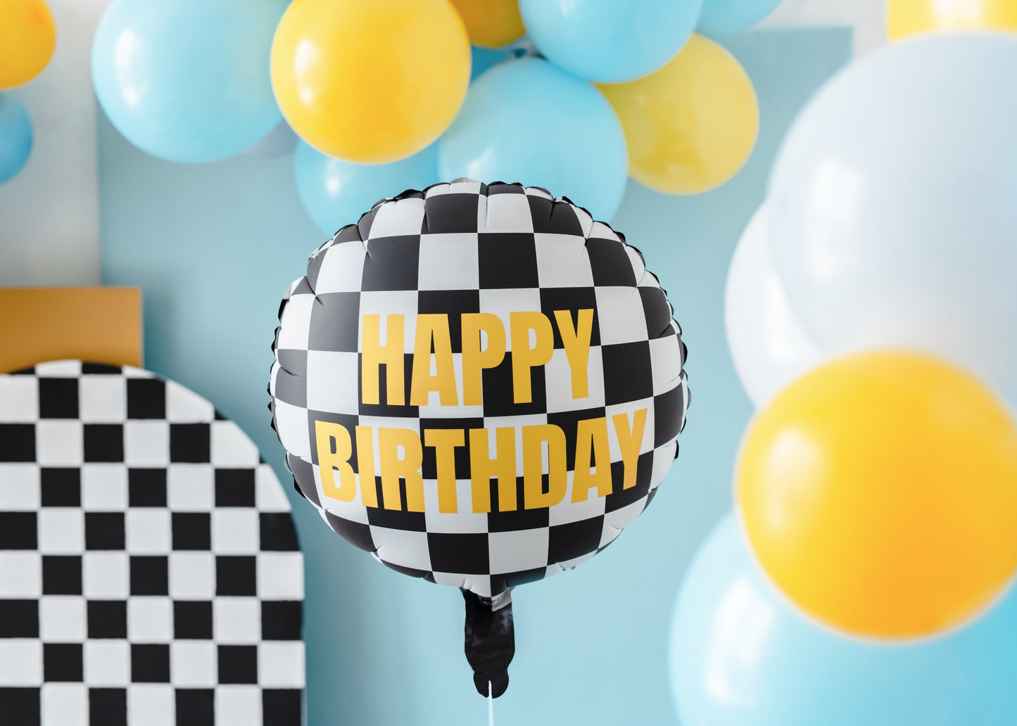 Foil balloon with checkered pattern and "Happy Birthday" text.