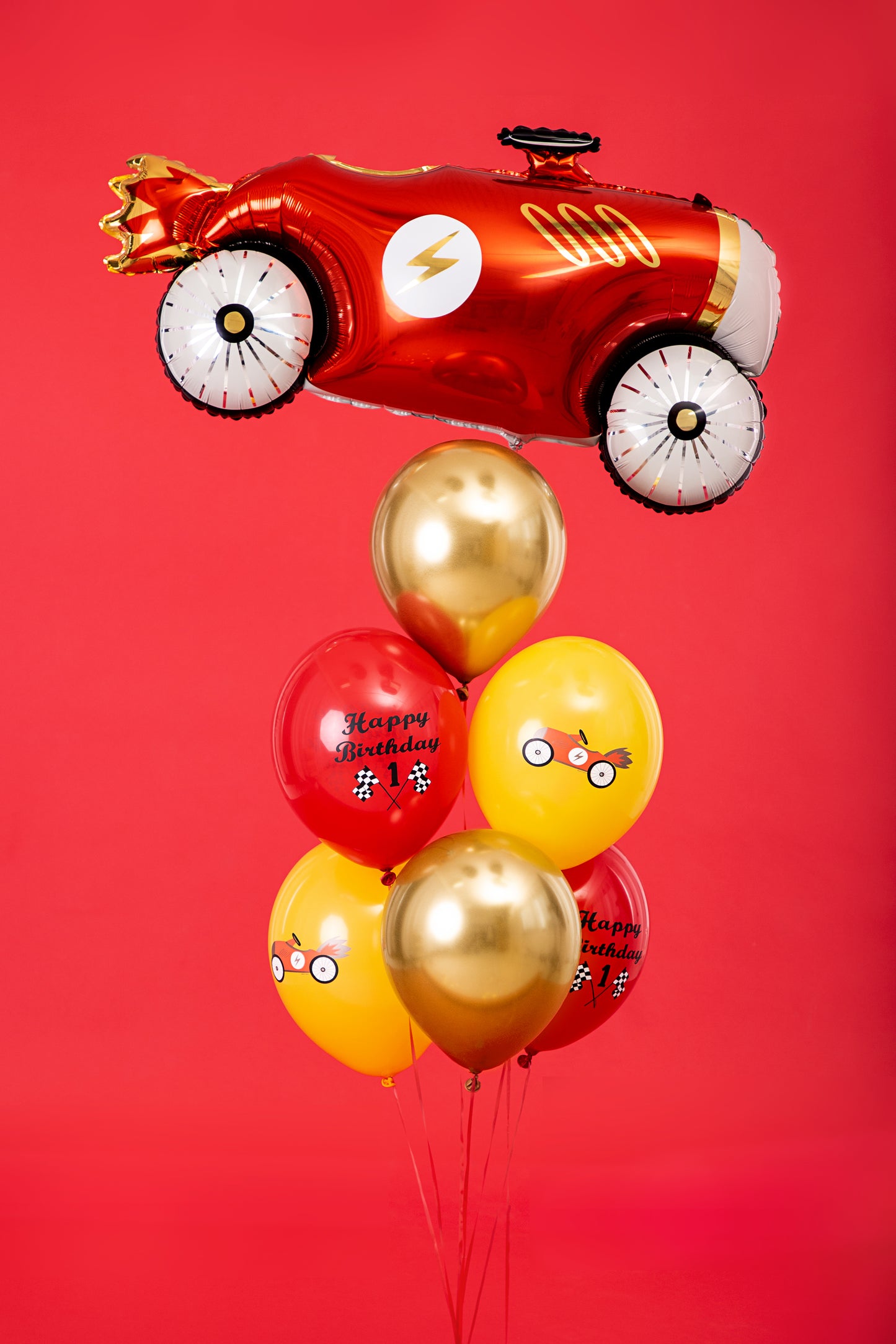 Race car printed latex balloons in red, yellow, blue, and gold.