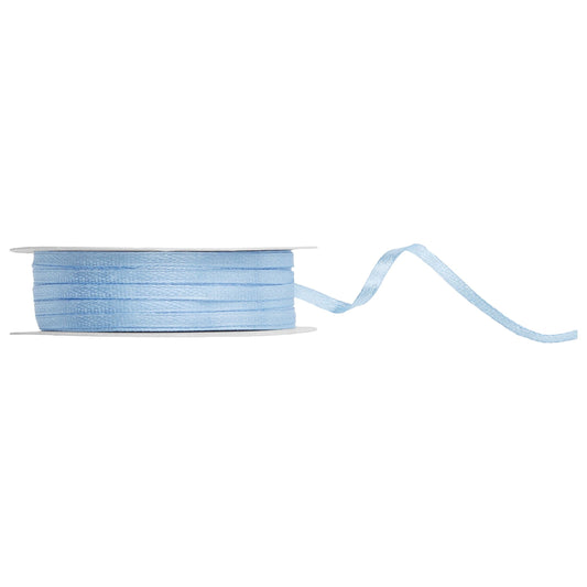 Spool of misty blue ribbon on a white background