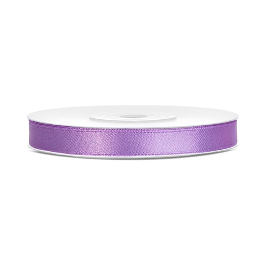 Roll of purple satin ribbon on a white background