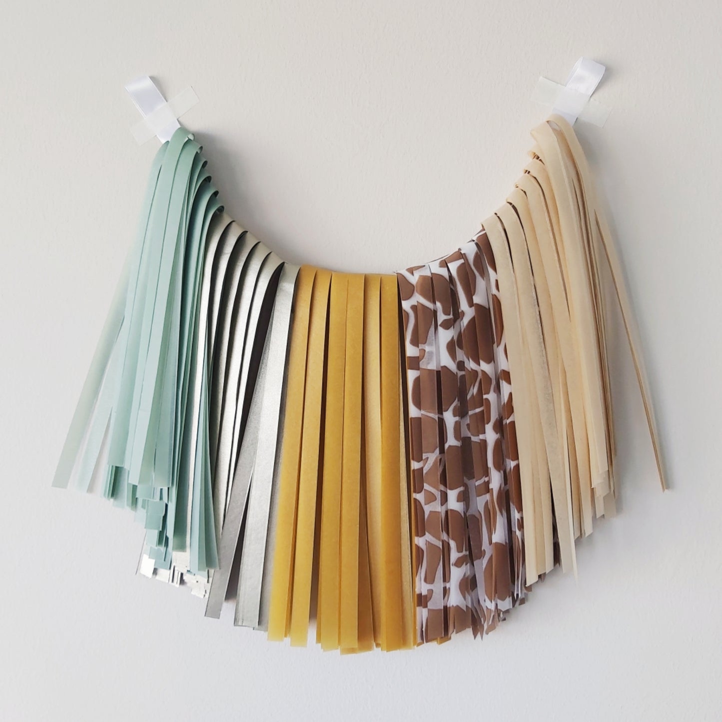 Colorful fabric tassel garland on a white background