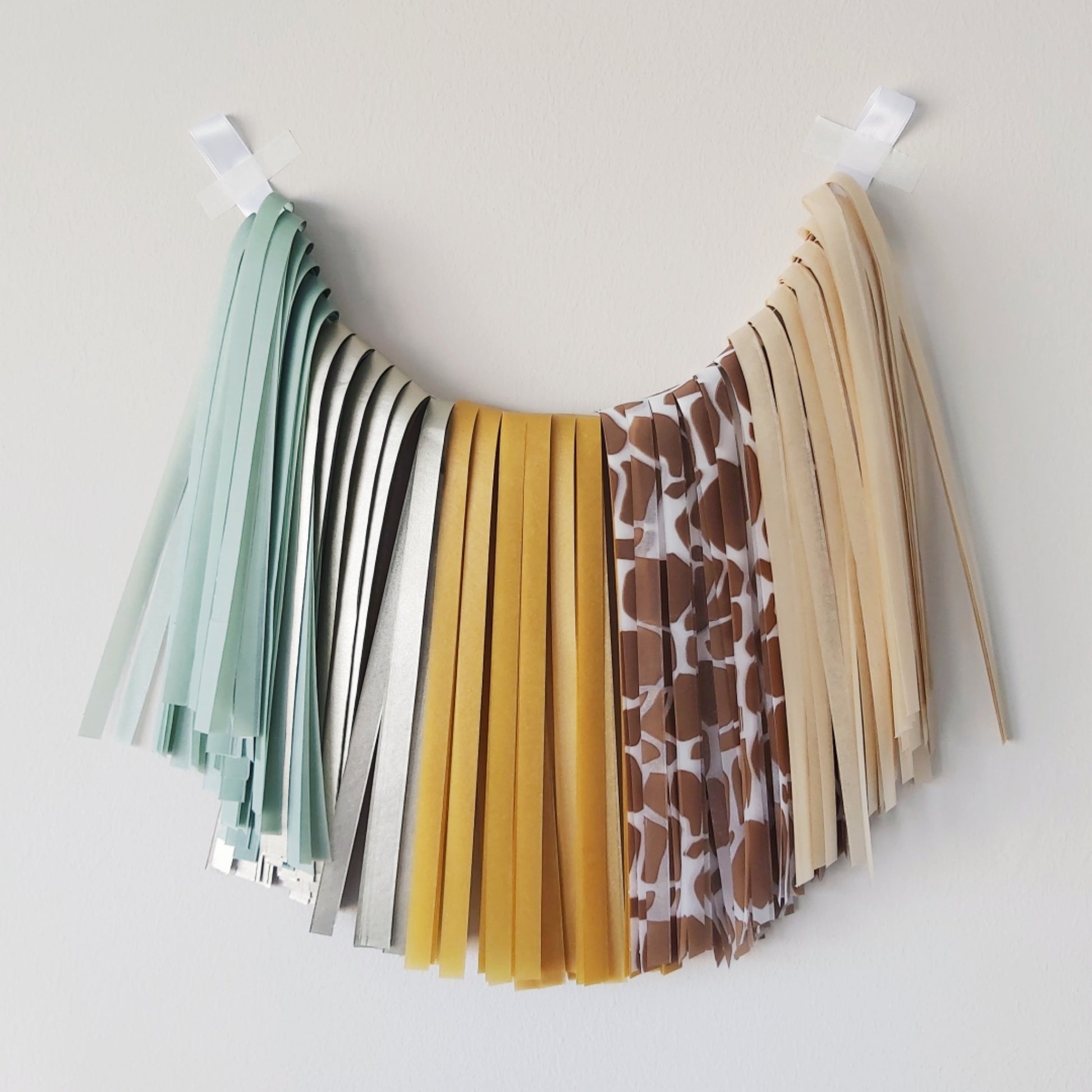 Colorful fabric tassel garland on a white background