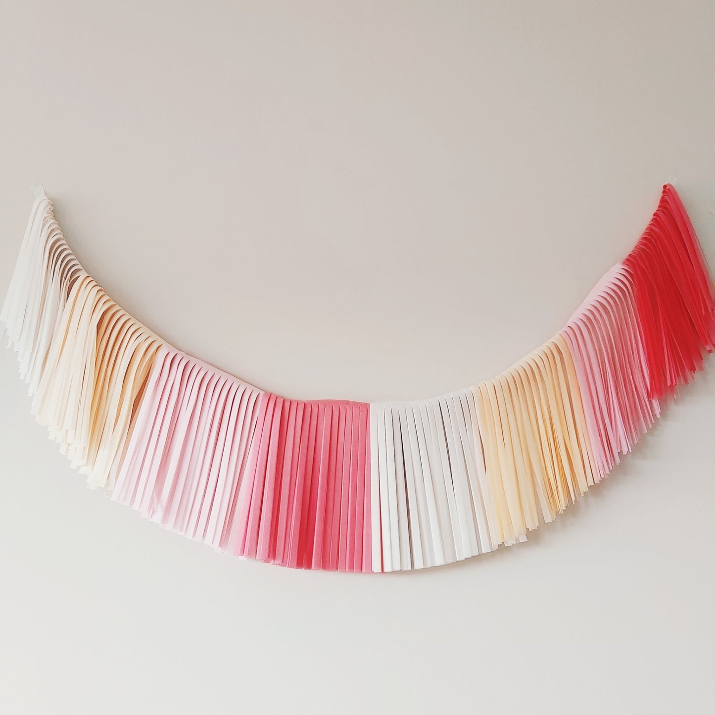 Colorful paper strip garland on a plain background