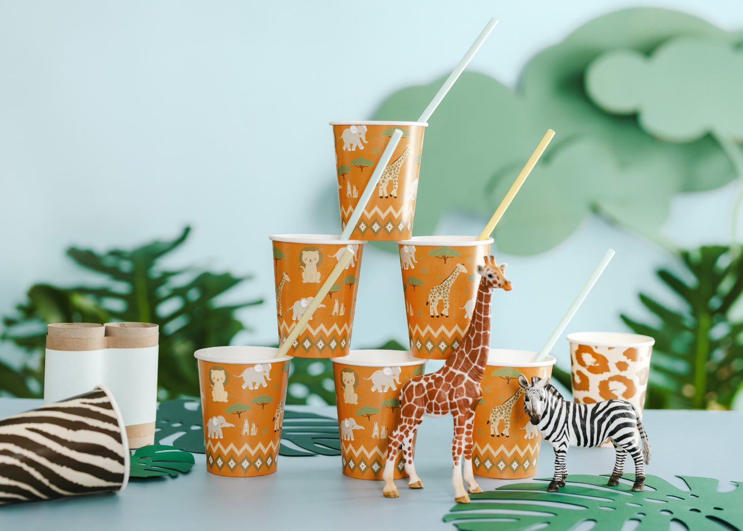 Jungle-themed paper cups with animal patterns on a light blue background