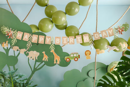 Jungle-themed birthday banner with balloons and decorations on a light blue background