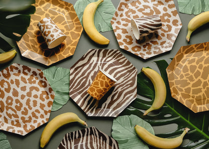 Hexagonal plates with animal print patterns on a table with bananas.
