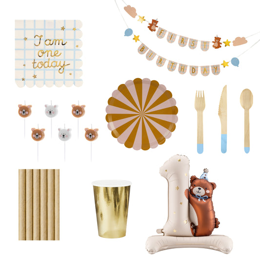 Collection of birthday party decorations including a banner, balloons, and cutlery on a white background.